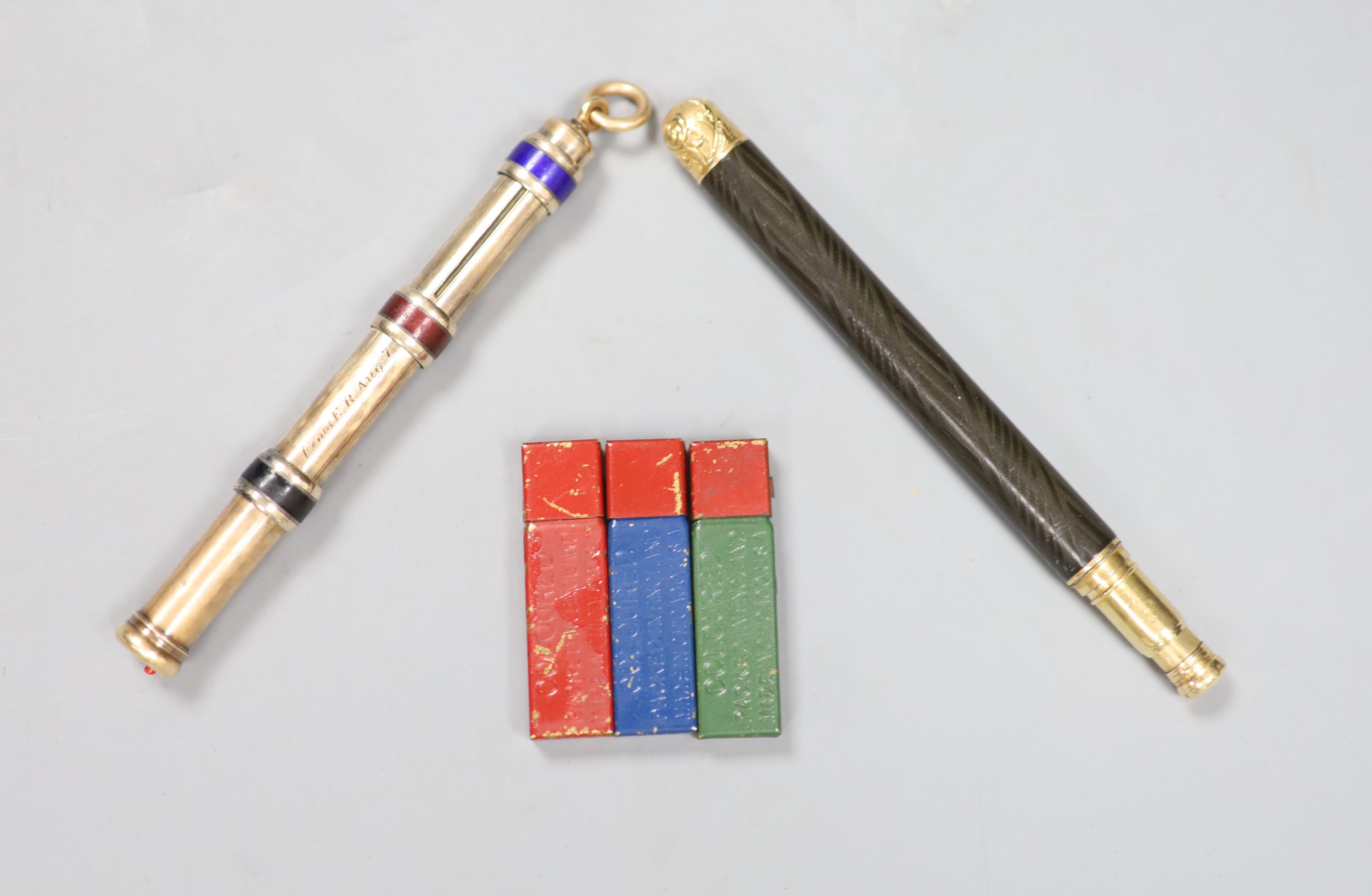 A late Victorian 15ct overlaid and enamel triple propelling pencil, one other pencil and three small tins of leads.